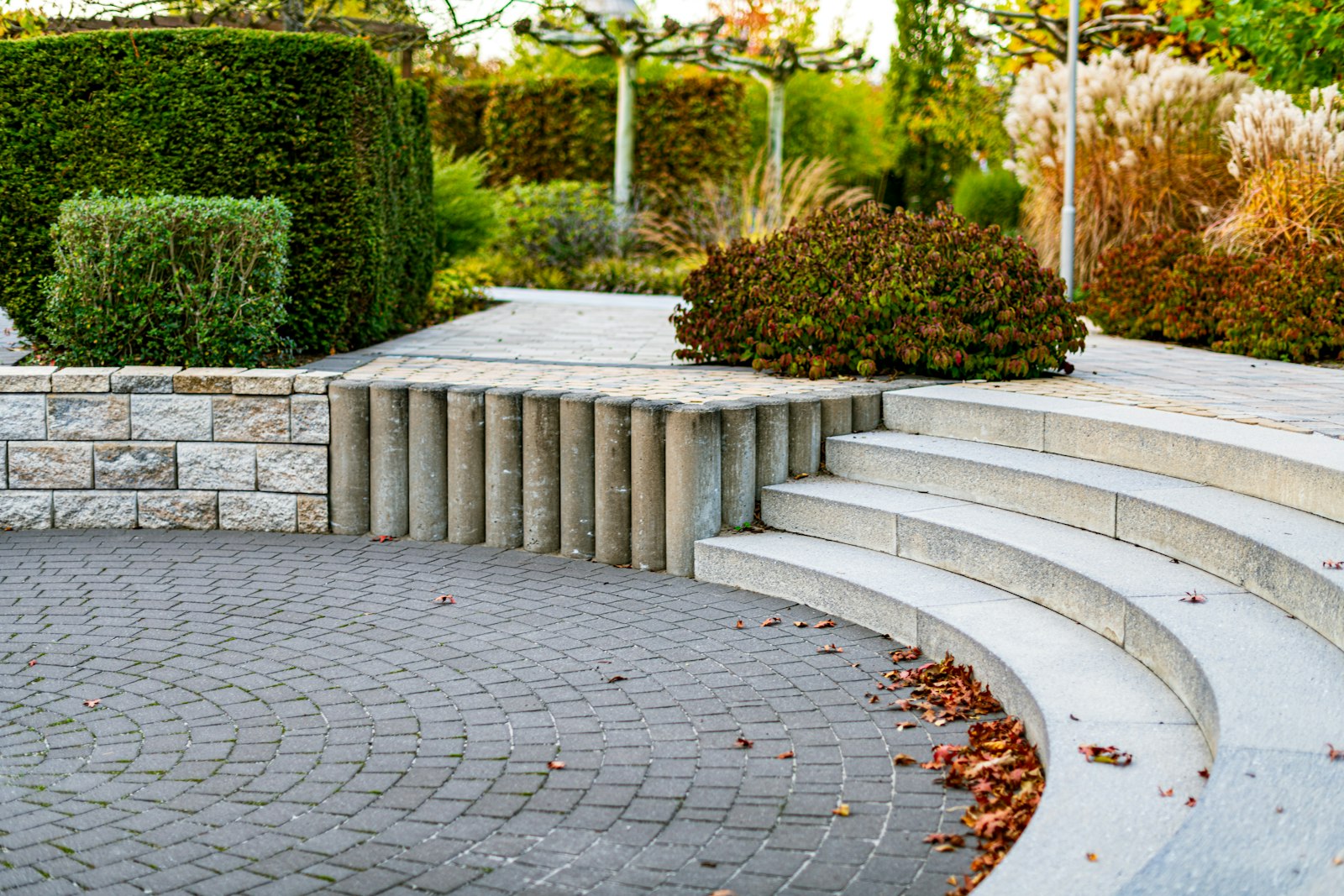 Curved natural stone steps in a garden with autumn planting